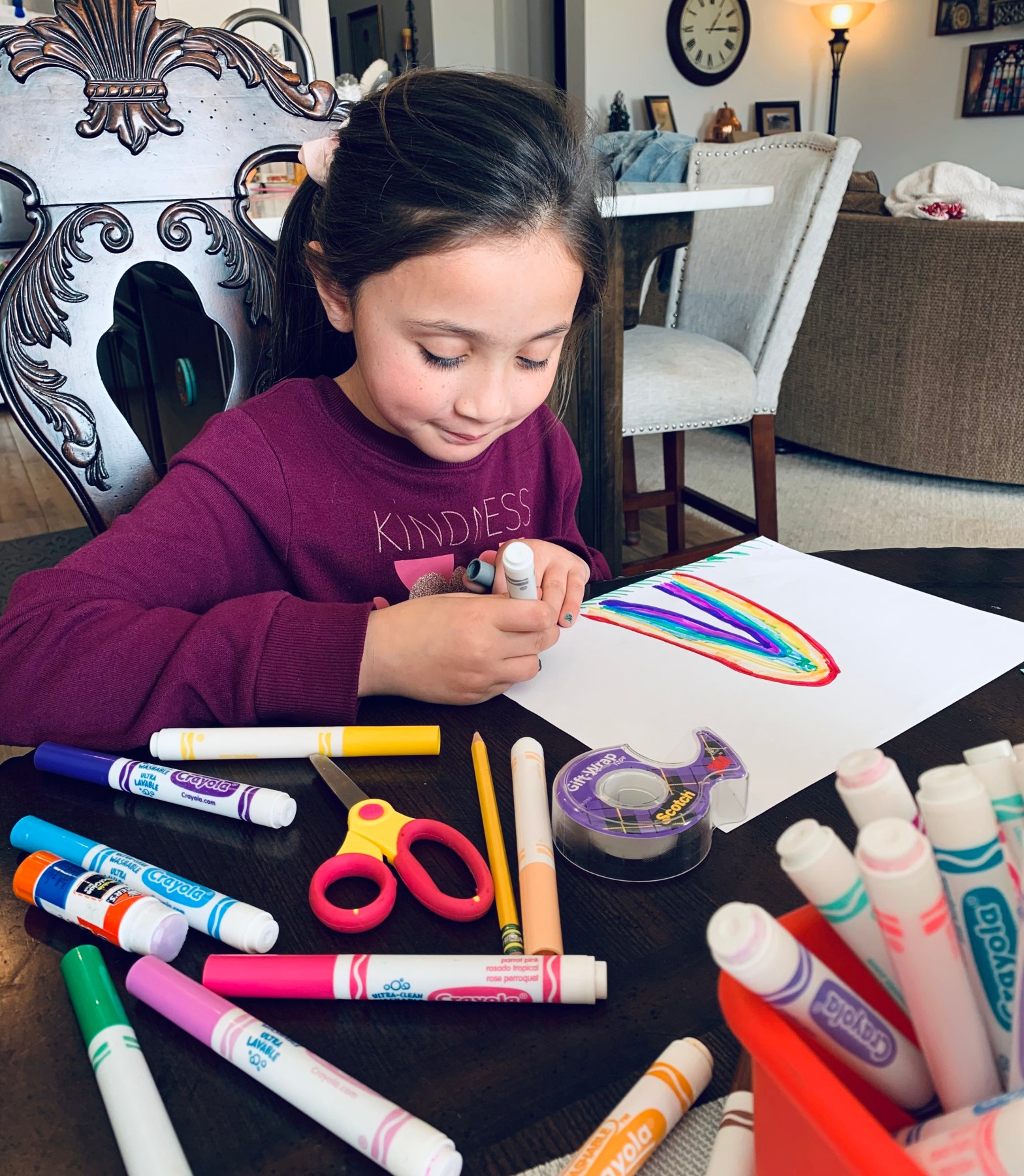 Jemma coloring with markers, drawing a St. Patrick's Day rainbow